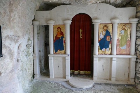 This is in a cave in Greece that's part of a monastery. This looks like it might be a confessional. It shows the 3 main icons -- Mary holding the Baby Jesus. Jesus holding the Bible and John the Baptist. 